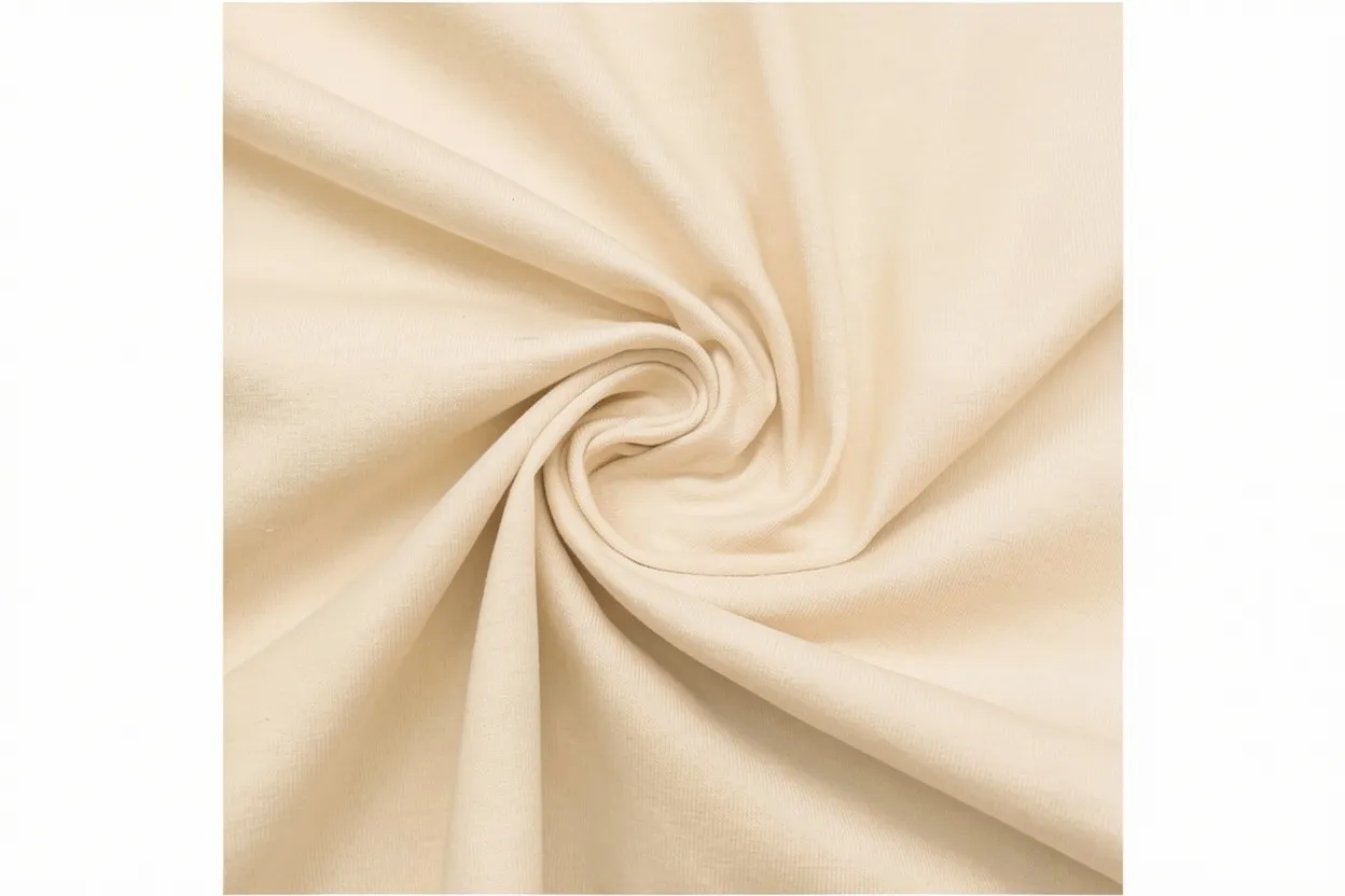 Anti-microbial knit fabric in pale champagne cotton with technical performance treatment, manufactured at Apex Corporation knitwear factory in Karachi Pakistan